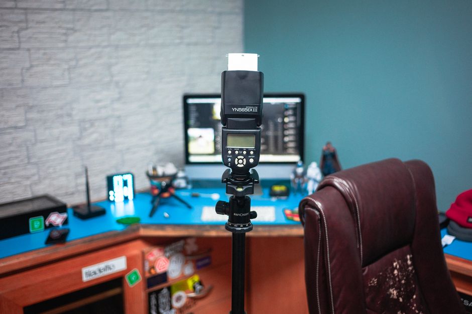 A modern photography studio setup with camera equipment and computer on a desk.