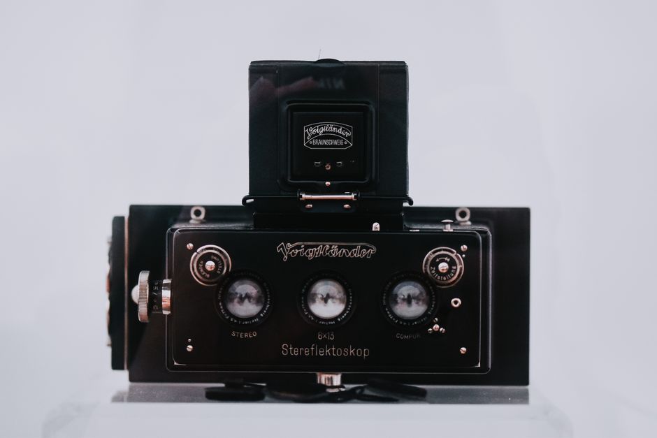 Close-up of a vintage Voigtländer stereoscopic camera in a museum setting.